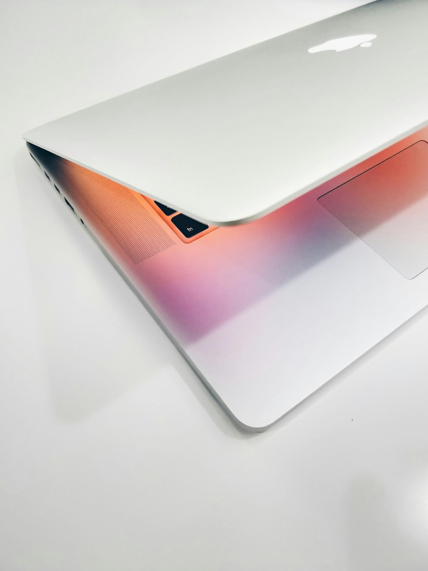 A modern laptop bathed in warm gradient light